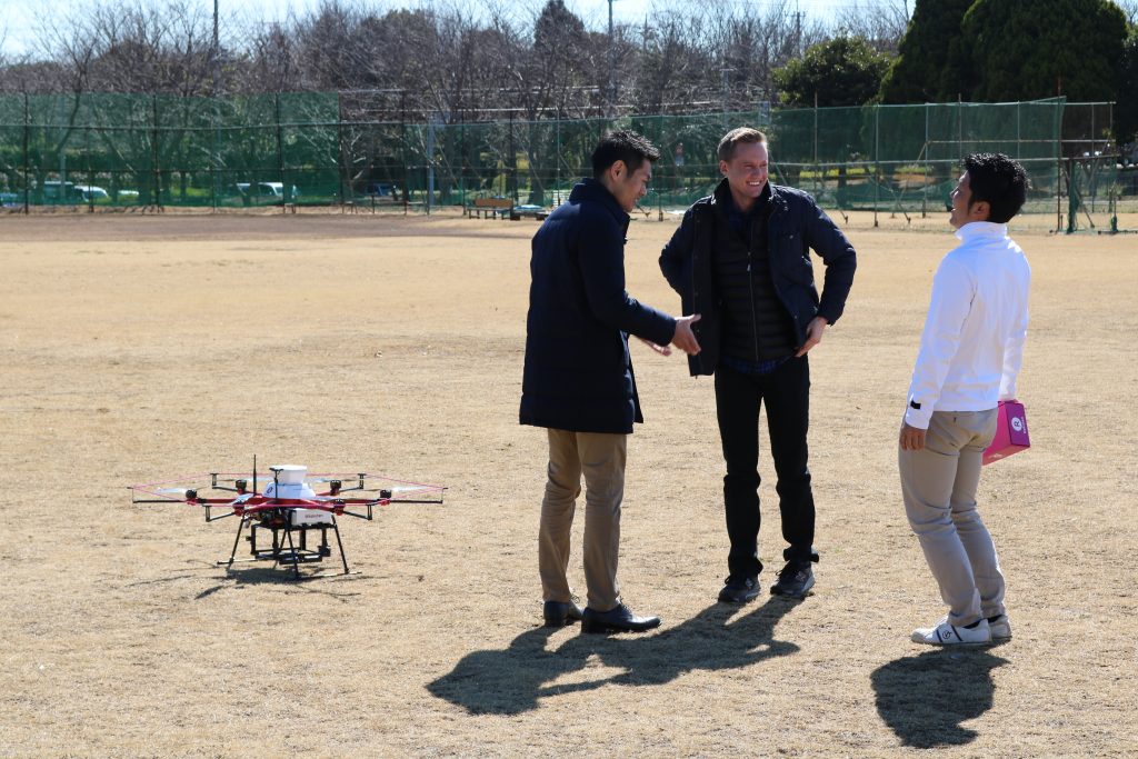 Ripley jokes with members of the Rakuten drone team.