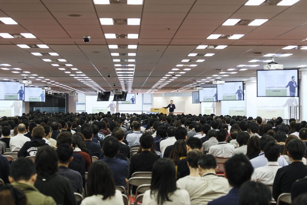 The Asakai venue seats around 2,000 employees. Thousands more tune into the weekly meeting from their desks via a videoconference system.
