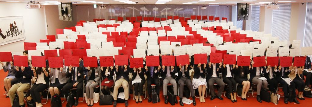 The new graduates wrote their goals on colored paper, and coordinated at the ceremony to spell the letters "R20," celebrating Rakuten's 20 years of business.