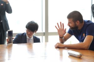 FC Barcelona star Gerard Pique waves to young fans during Viber video call in Tokyo.