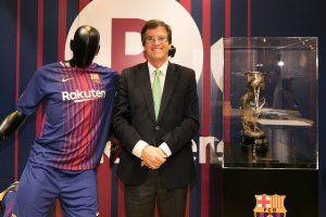 Football memorabilia collector Agesilaos Papadopoulos stands next to a replica of the Macaya Cup won by FC Barcelona in the 1901-1902 season at the Rakuten Cafe in Shibuya, Tokyo.