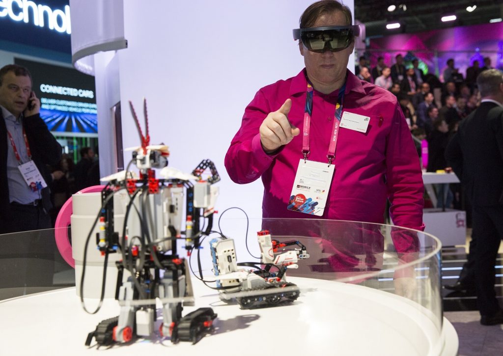 A visitor to Mobile World Congress operates a robot using augmented reality technology.