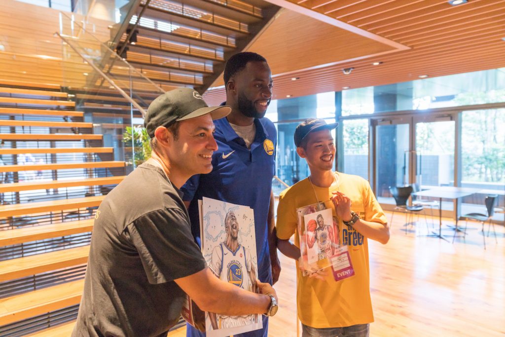 World Renowned caricature artists Dai Tamura (right) presenting Draymond Green with his portrait.