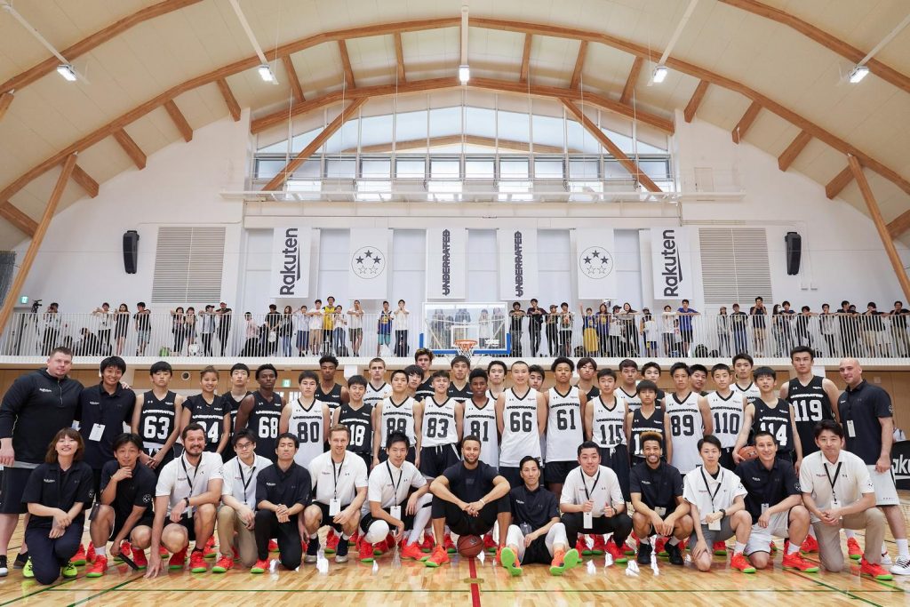 Curry with coaches and players on the second day of the camp.