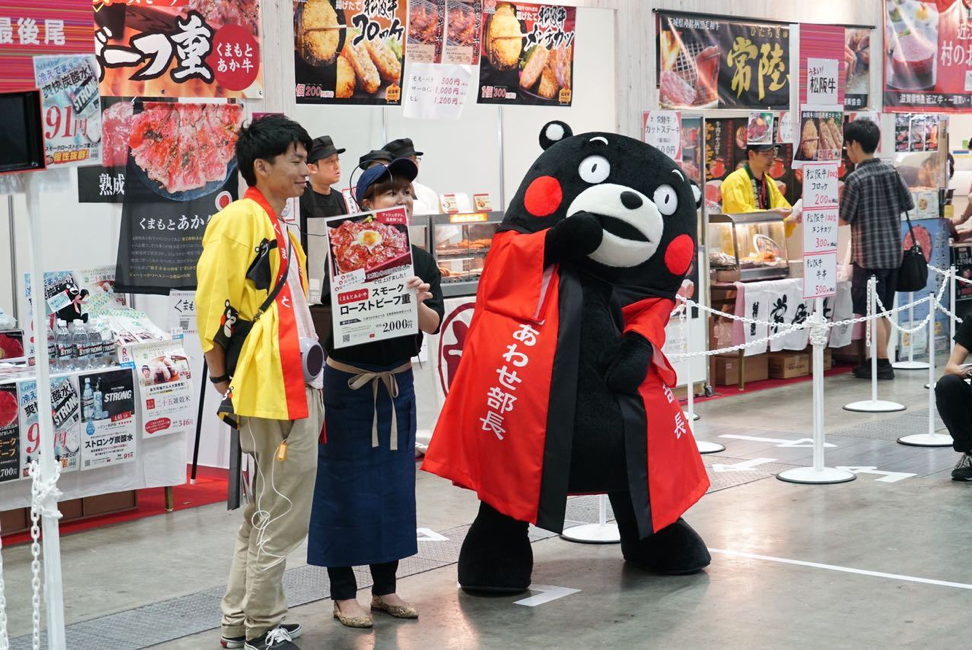 Kumamon (right) made an appearance in the exhibition hall at Rakuten Optimism, much to the delight of both merchants and customers.