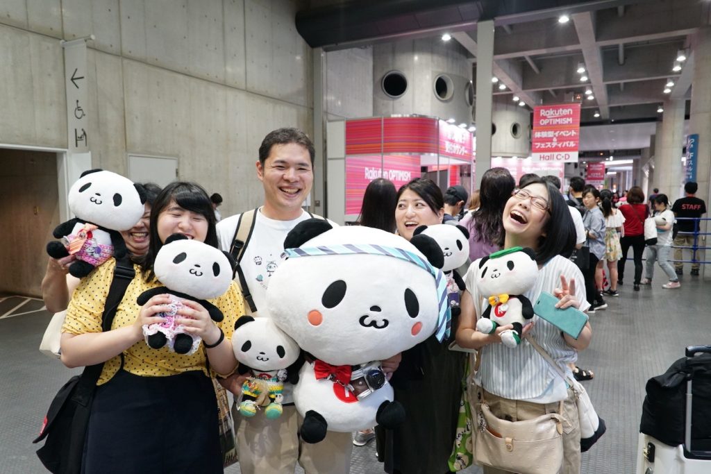 A group of Future World visitors show off their panda spirit in Yokohama.
