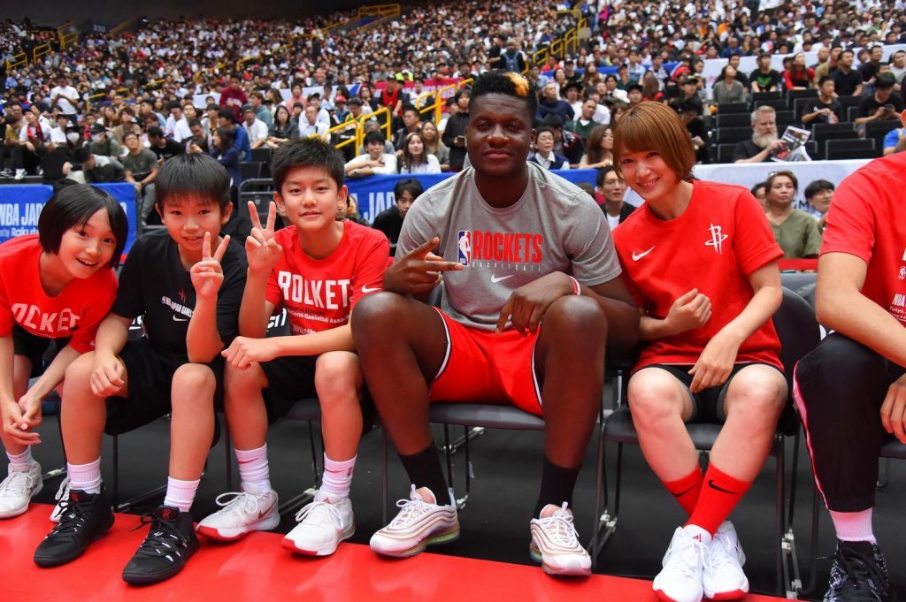 Rockets center Clint Capela and former W.League champion Mao Okada sit with young fans.